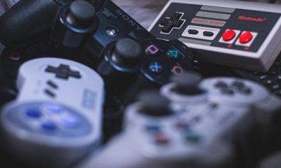 Close-up on a stash of retro Sony and Nintendo game console controllers