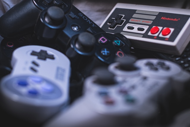 Close-up on a stash of retro Sony and Nintendo game console controllers
